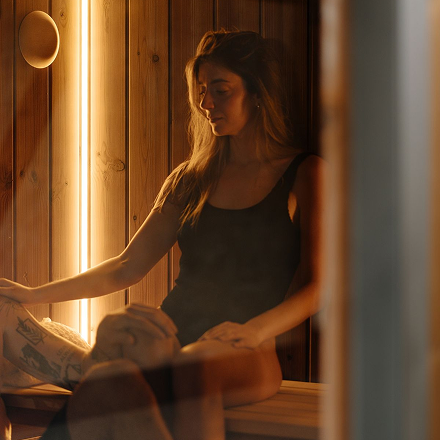 Guest relaxing in the wooden sauna at SOMA